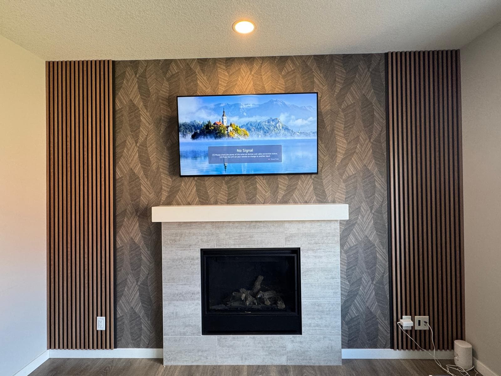 Dark charcoal WPC slat panels flanking fireplace